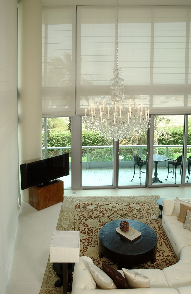 This is an example of a medium sized contemporary formal open plan living room in Miami with beige walls, no fireplace, a freestanding tv and beige floors.
