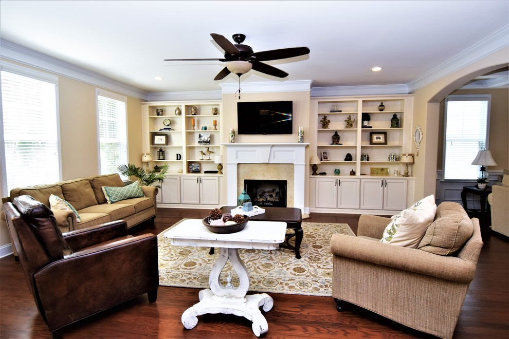 Example of a mid-sized beach style formal and open concept dark wood floor and brown floor living room design in Atlanta with beige walls, no fireplace and a tv stand