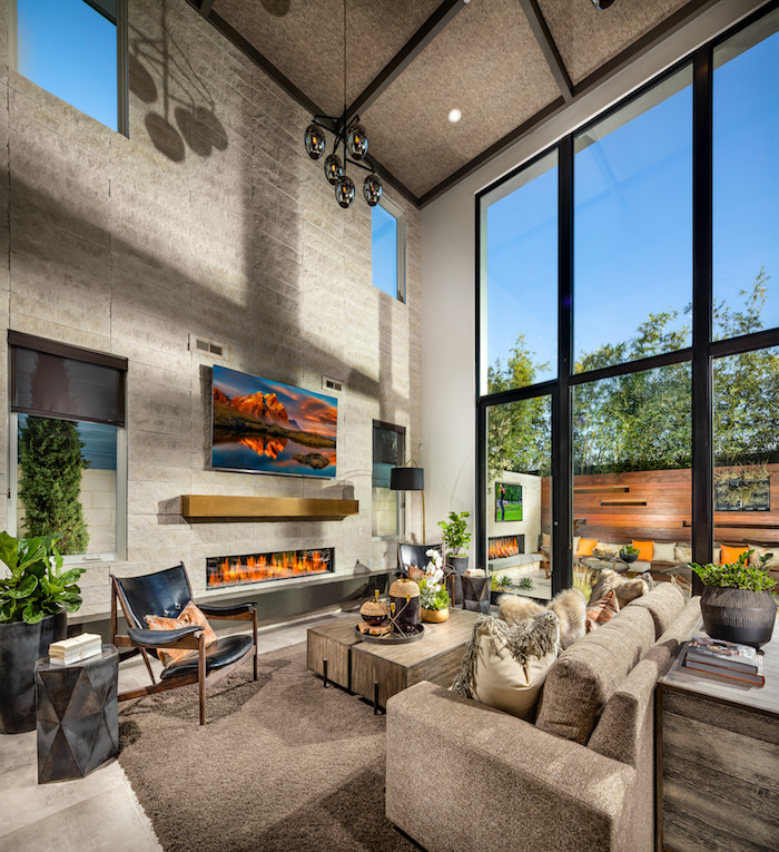 Huge trendy open concept gray floor living room photo in Orange County with white walls, a ribbon fireplace, a stone fireplace and a wall-mounted tv
