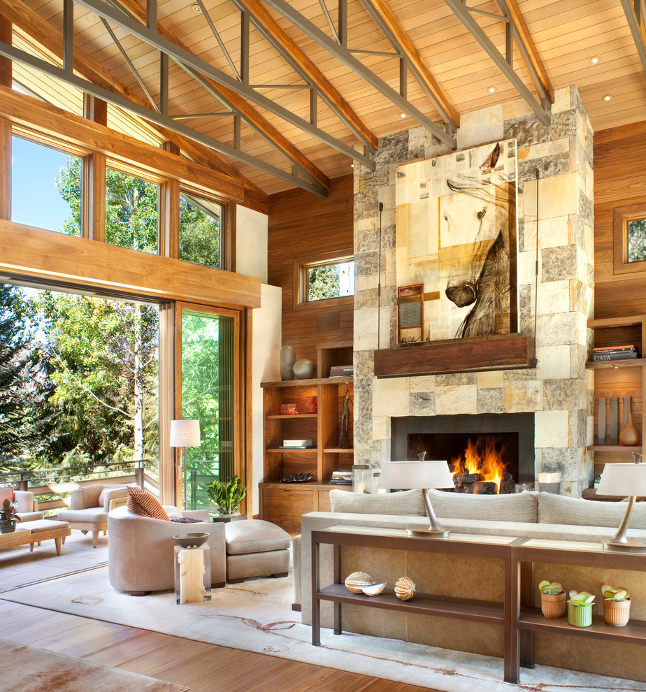 Large mountain style living room photo in Denver with a standard fireplace and a stone fireplace