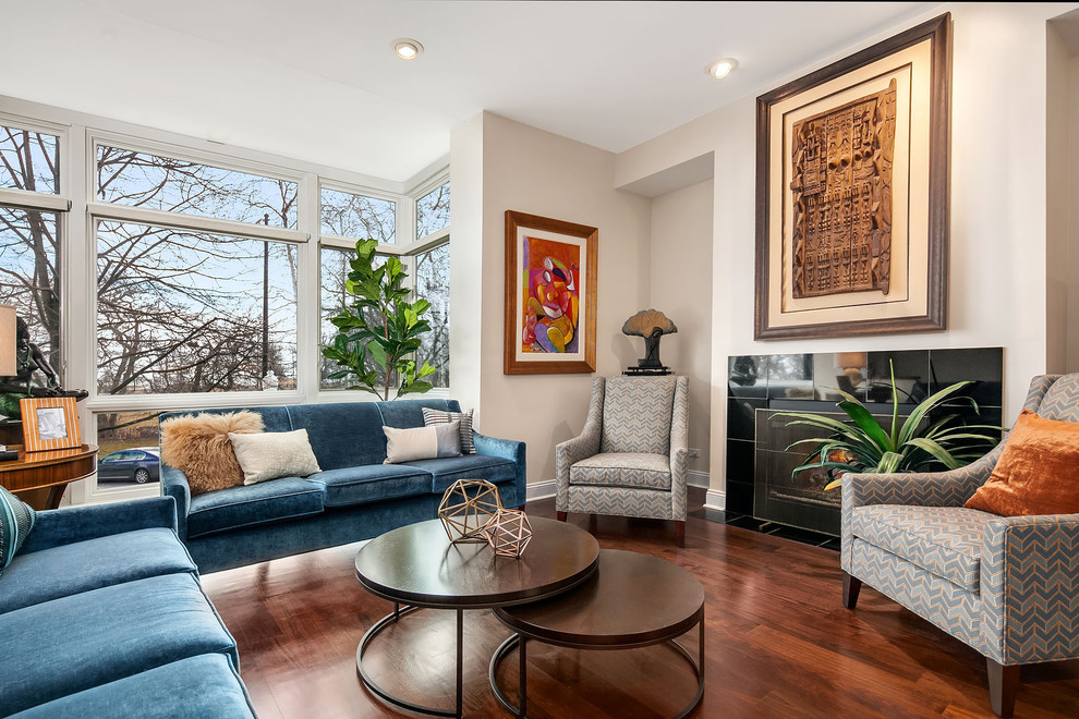 Photo of a large contemporary formal open plan living room in Chicago with white walls, dark hardwood flooring, a standard fireplace, brown floors, a tiled fireplace surround and no tv.