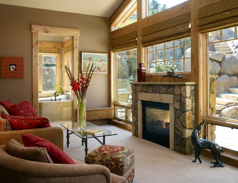 Mid-sized elegant enclosed carpeted living room photo in Denver with brown walls, a two-sided fireplace and a stone fireplace