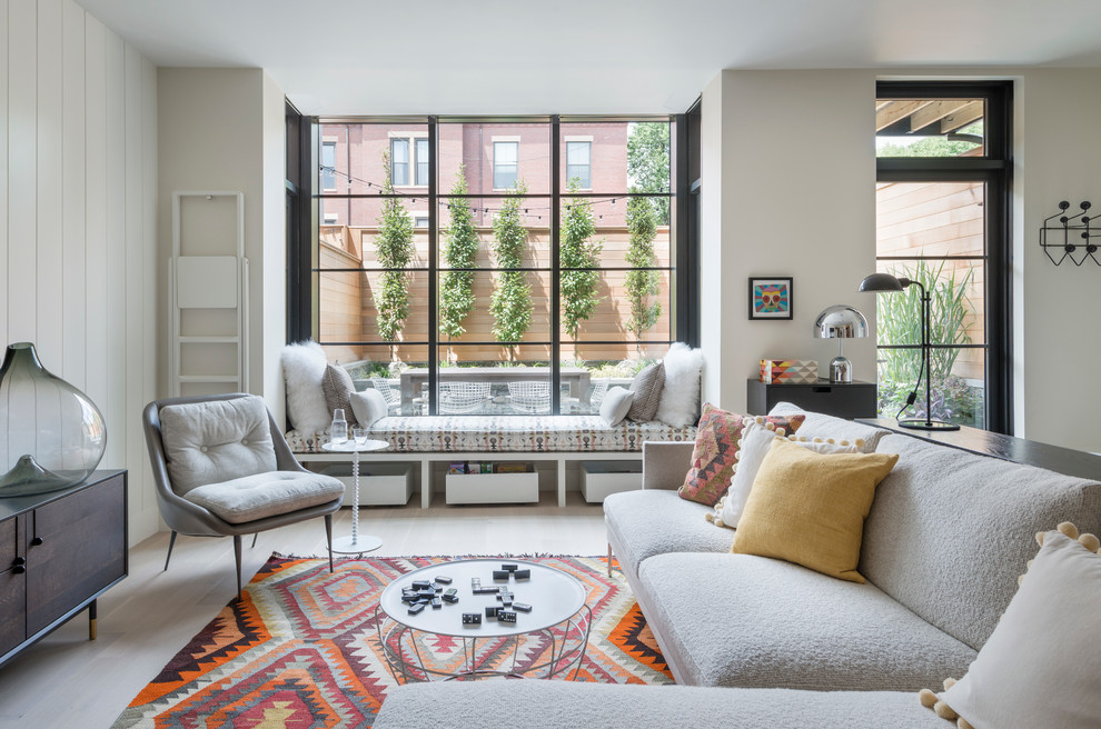 1960s formal and open concept light wood floor living room photo in Boston with white walls and no tv