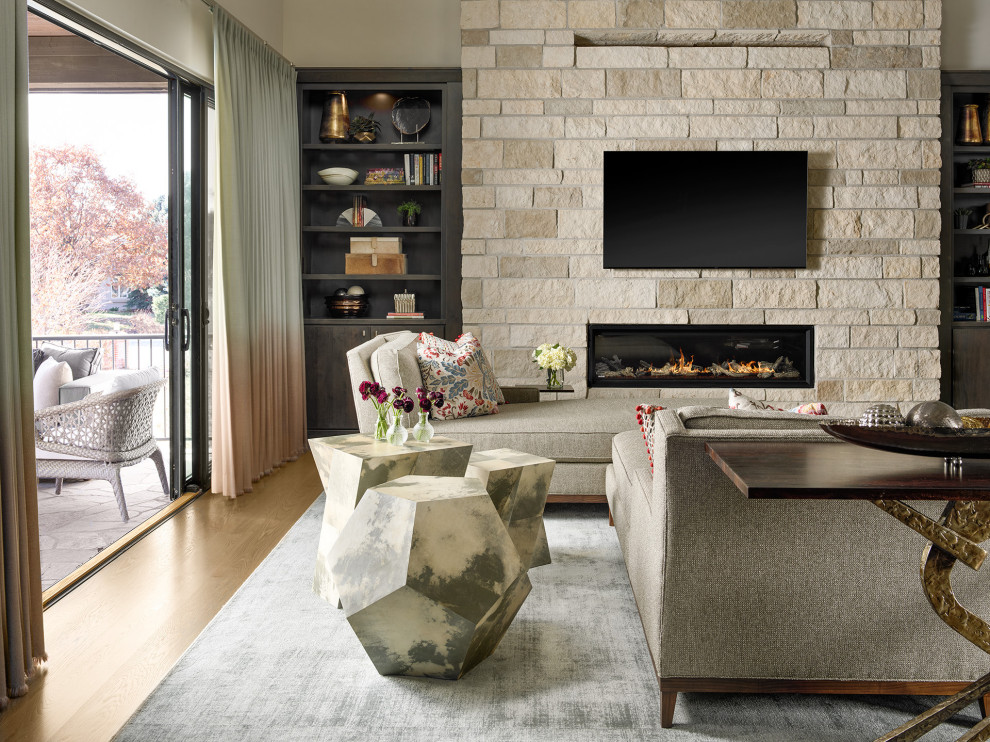 デンバーにある広いトランジショナルスタイルのおしゃれなLDK (無垢フローリング、横長型暖炉、石材の暖炉まわり、壁掛け型テレビ、茶色い床、ベージュの壁) の写真