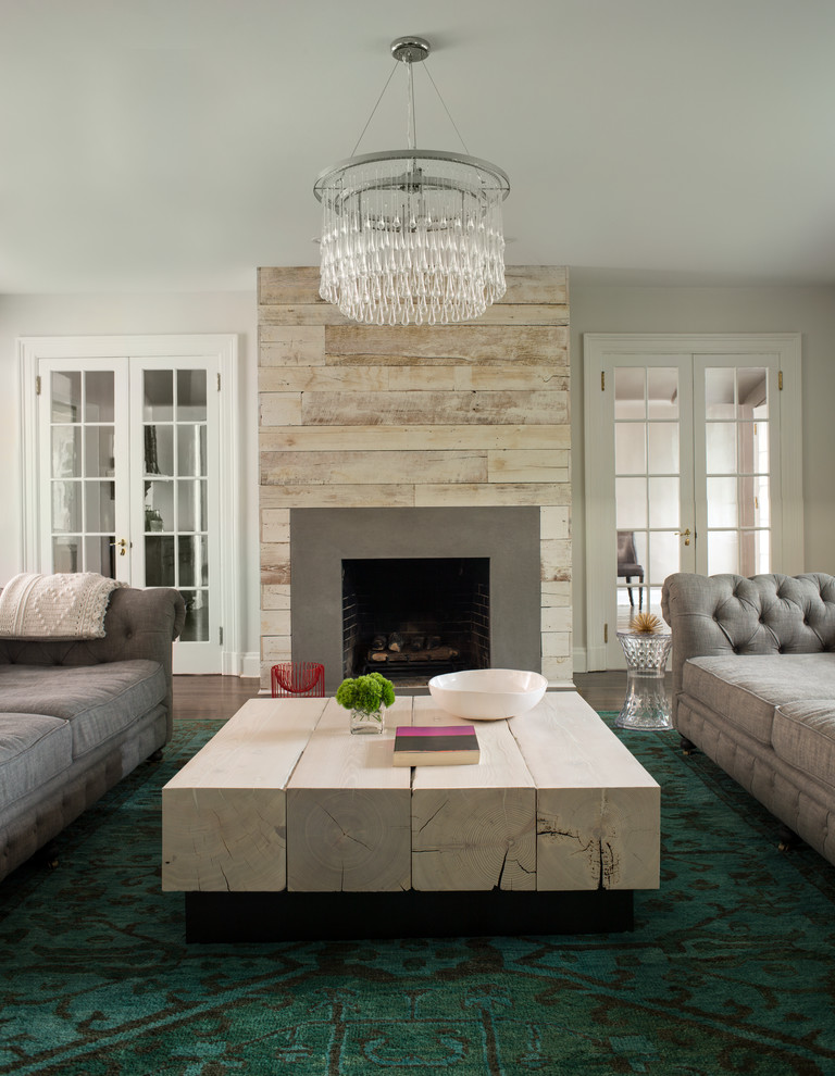 This is an example of a contemporary formal living room in New York with a standard fireplace.