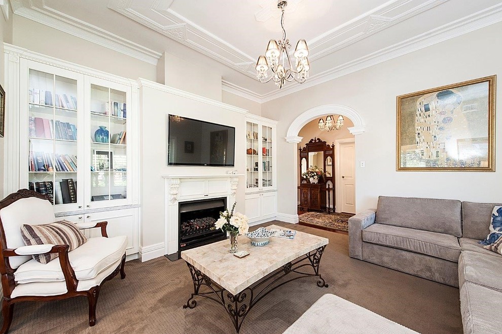 Mid-sized elegant formal and enclosed carpeted living room photo in Perth with beige walls, a standard fireplace, a plaster fireplace and a wall-mounted tv
