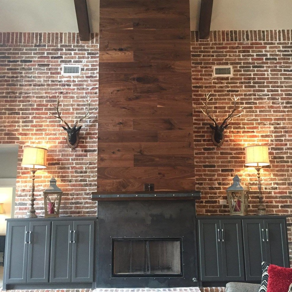 Inspiration for a large industrial open concept dark wood floor living room remodel in Austin with beige walls, a standard fireplace and a metal fireplace