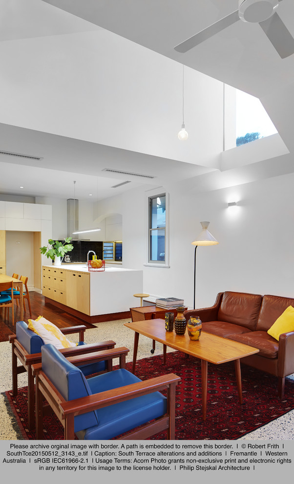 This is an example of a small contemporary open plan living room in Perth with white walls, concrete flooring and a wall mounted tv.