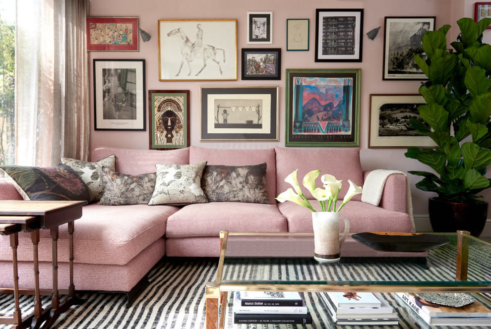 Eclectic living room in London with pink walls.