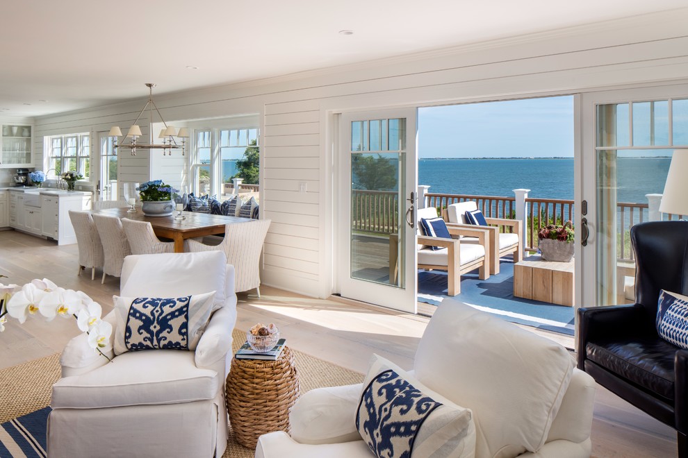 Photo of a large nautical formal open plan living room in New York with white walls, a standard fireplace, a wall mounted tv, light hardwood flooring and a tiled fireplace surround.