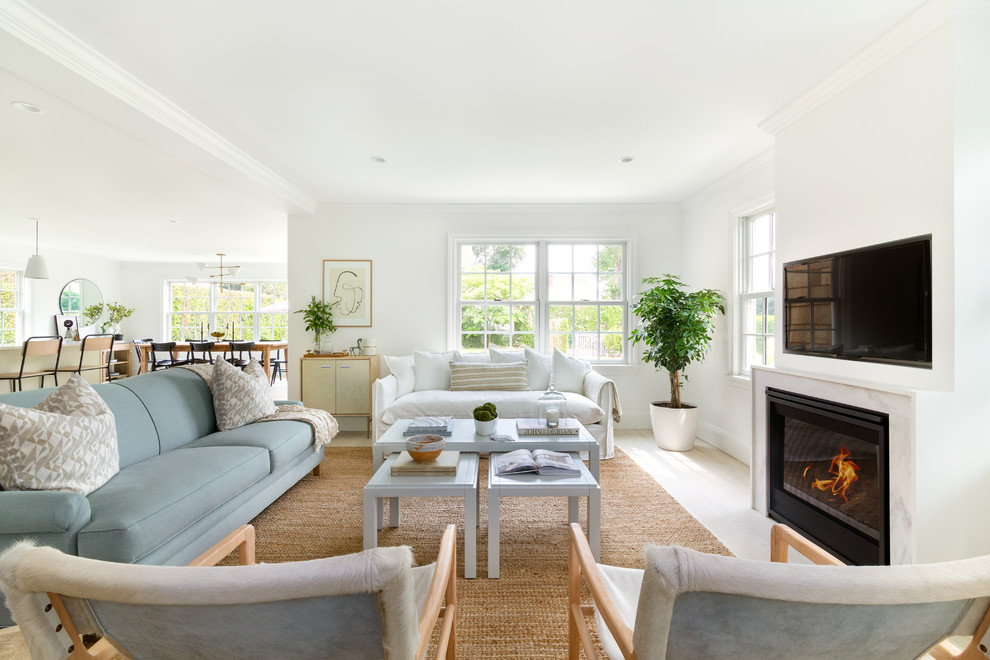 Inspiration for a large transitional open concept light wood floor and beige floor living room remodel in New York with white walls, a standard fireplace, a stone fireplace and a wall-mounted tv
