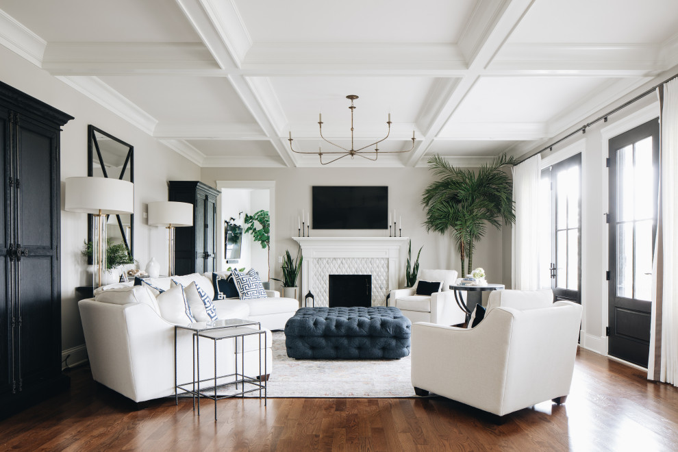 Transitional enclosed medium tone wood floor, brown floor and coffered ceiling living room photo in Chicago with gray walls, a standard fireplace and a wall-mounted tv