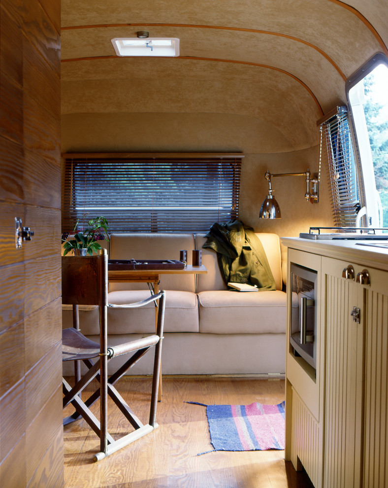 Cette image montre un petit salon chalet ouvert avec un mur beige, parquet clair, aucune cheminée et un sol beige.