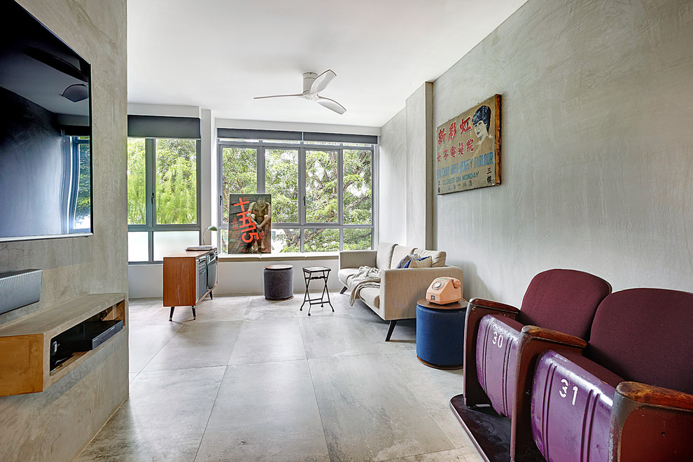 На фото: открытая гостиная комната в стиле лофт с серыми стенами, бетонным полом и телевизором на стене без камина