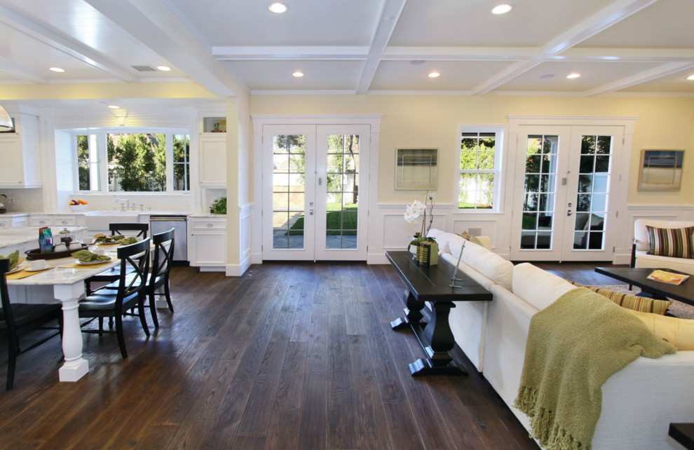 Large trendy open concept dark wood floor and brown floor living room photo in Los Angeles with yellow walls