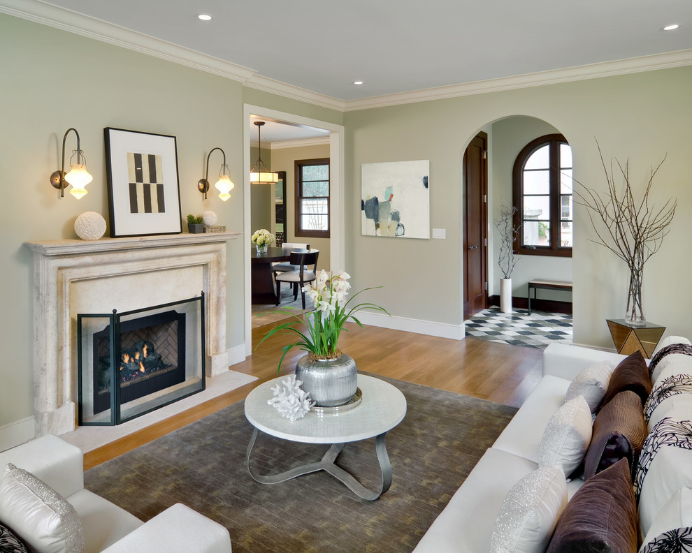 Example of a mid-sized tuscan light wood floor living room design in San Francisco with green walls, a standard fireplace and a stone fireplace