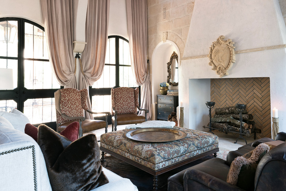 Diseño de salón para visitas cerrado mediterráneo grande sin televisor con suelo de piedra caliza, todas las chimeneas y marco de chimenea de yeso