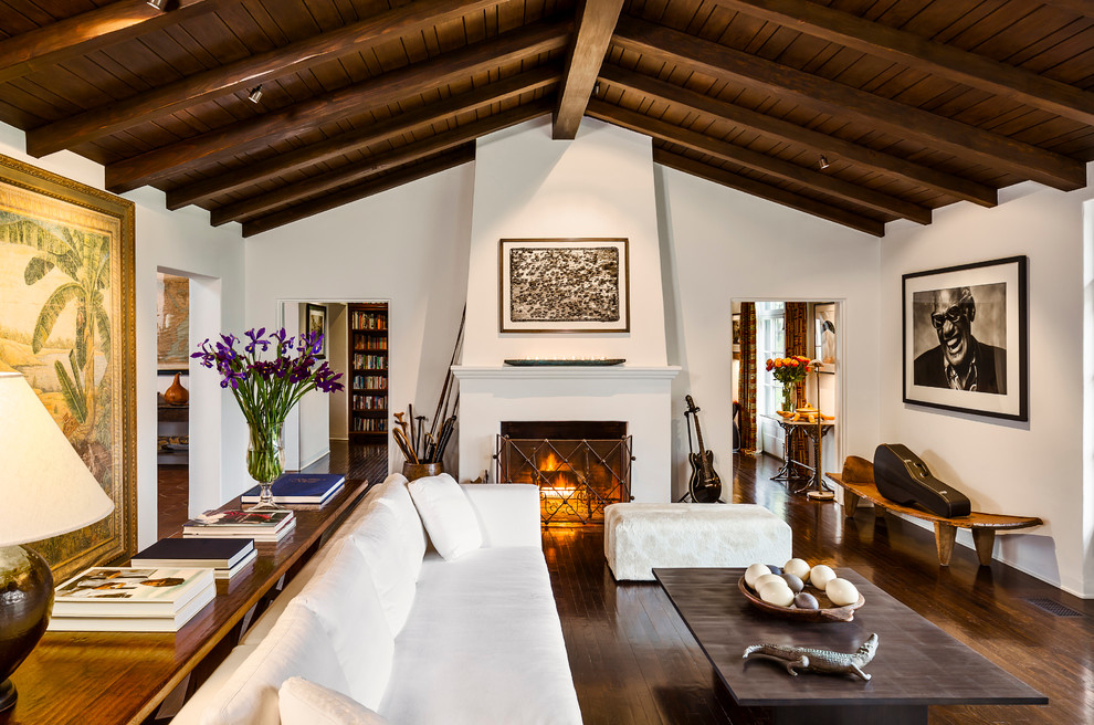 Living room - large mediterranean enclosed dark wood floor living room idea in Santa Barbara with white walls, a standard fireplace and a plaster fireplace