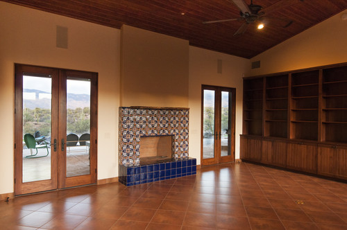 Photo of a large eclectic open plan living room in Phoenix with ceramic flooring and a tiled fireplace surround.