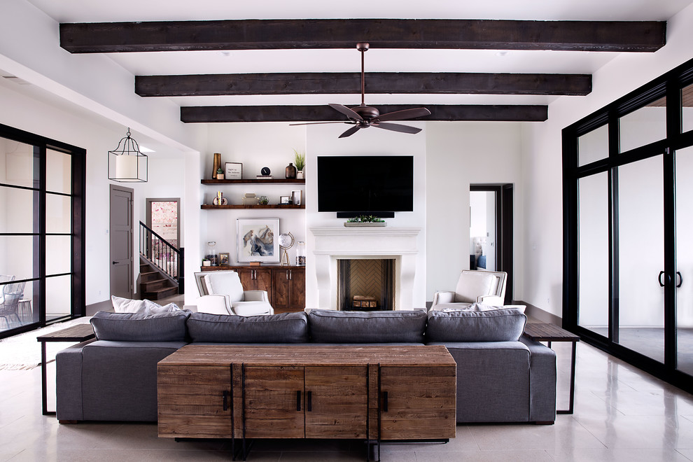 Medium sized classic formal open plan living room in Austin with white walls, a standard fireplace, a wall mounted tv, grey floors, concrete flooring and a plastered fireplace surround.