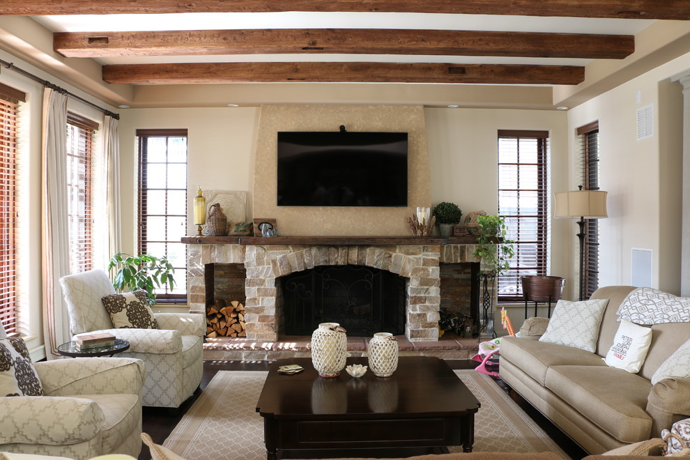 This is an example of a medium sized mediterranean enclosed living room in New York with beige walls, dark hardwood flooring, a standard fireplace, a brick fireplace surround and a wall mounted tv.