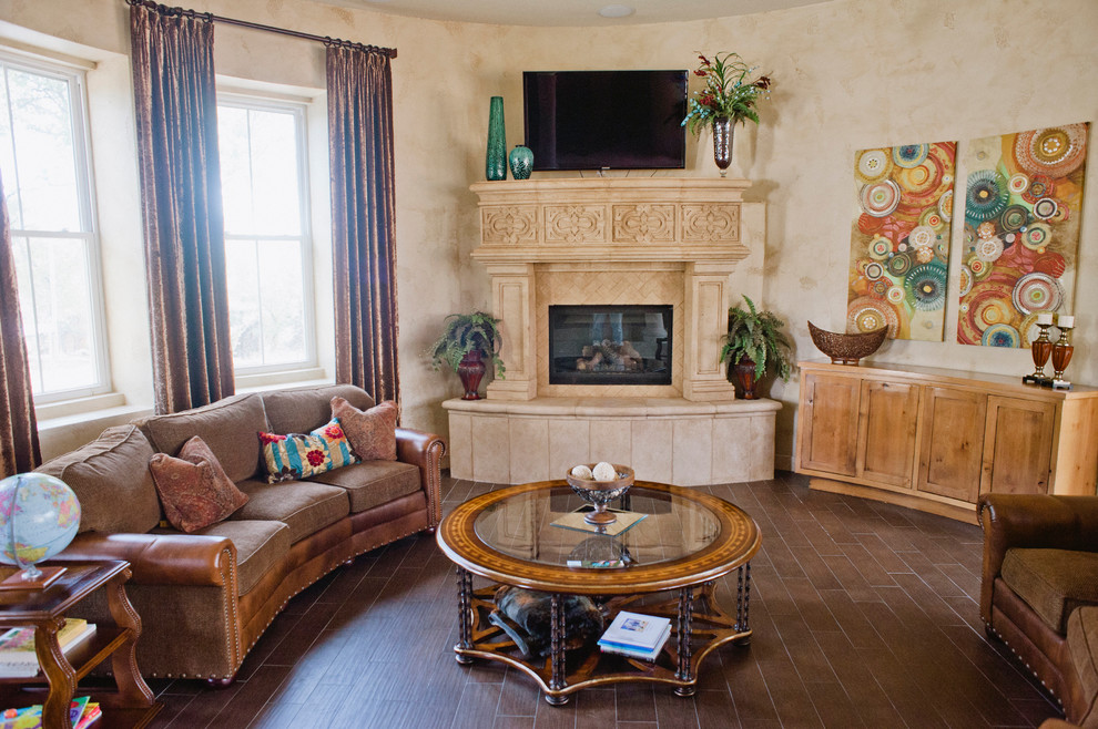 Large mountain style open concept ceramic tile living room photo in Austin with beige walls, a standard fireplace, a stone fireplace and a wall-mounted tv