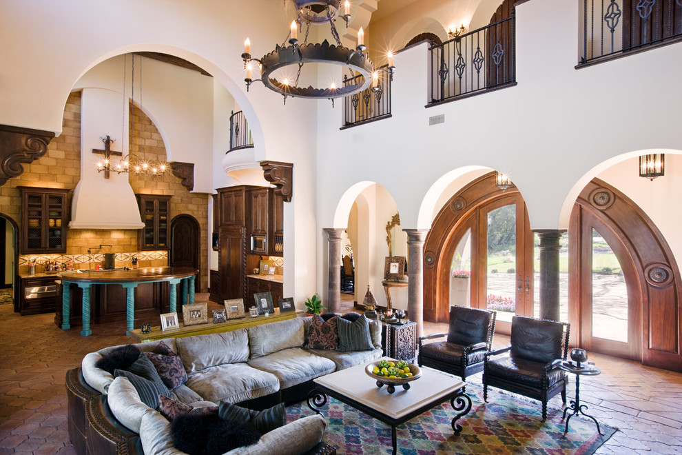 Mediterranean open plan living room in Austin with white walls.