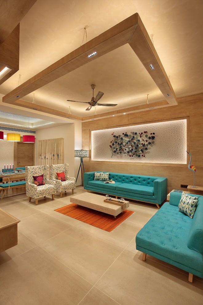 Contemporary open plan living room in Ahmedabad with white walls, no fireplace, no tv, beige floors and feature lighting.