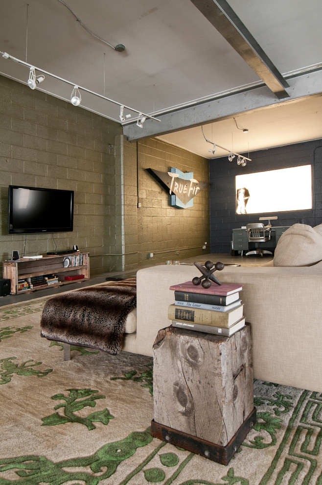 Living room - industrial open concept living room idea in Salt Lake City with a wall-mounted tv