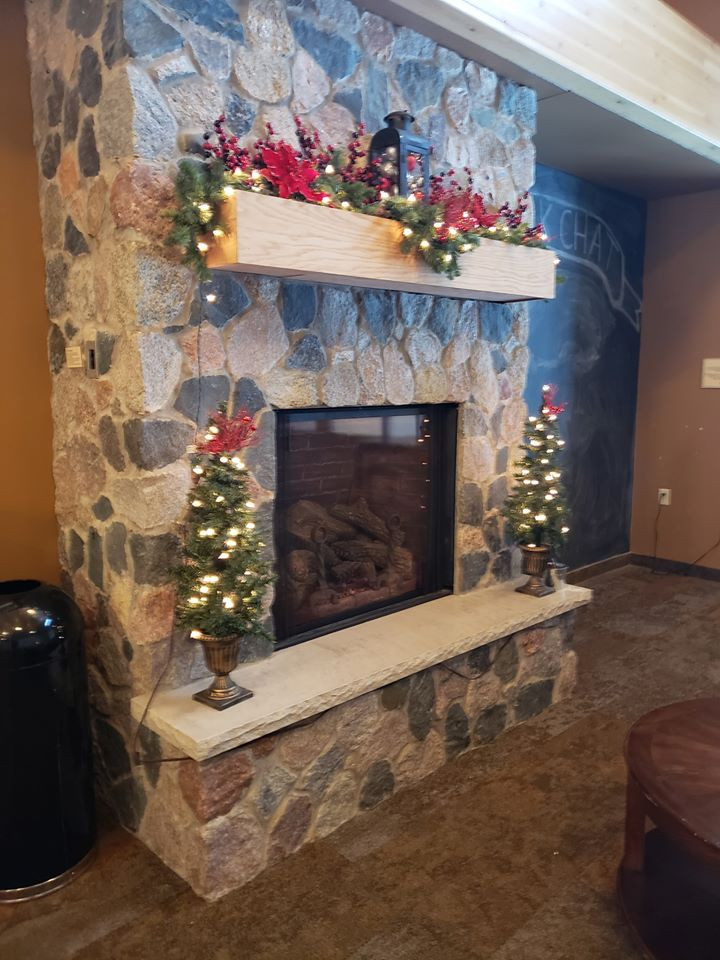 fieldstone fireplace with antique chair