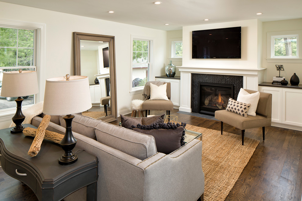 This is an example of a medium sized classic formal open plan living room in Minneapolis with white walls, dark hardwood flooring, a standard fireplace, a tiled fireplace surround and a wall mounted tv.
