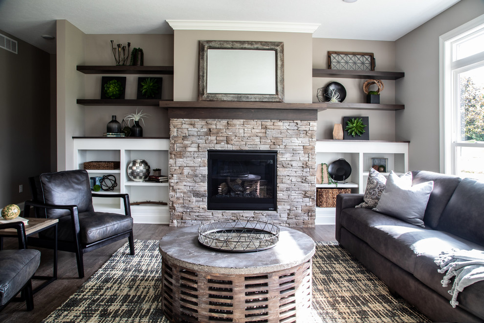 Example of a trendy formal dark wood floor and gray floor living room design in Cleveland with gray walls, a standard fireplace and a stone fireplace