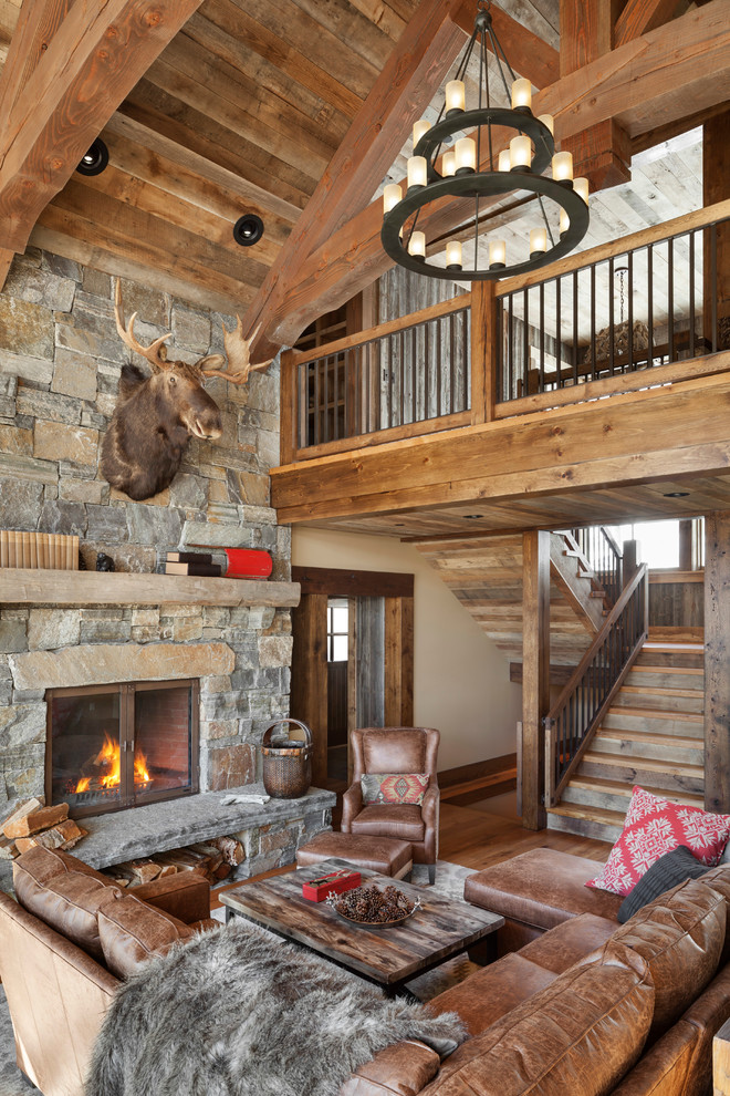 Inspiration for a rustic living room in Portland Maine with dark hardwood flooring, a standard fireplace and a stone fireplace surround.