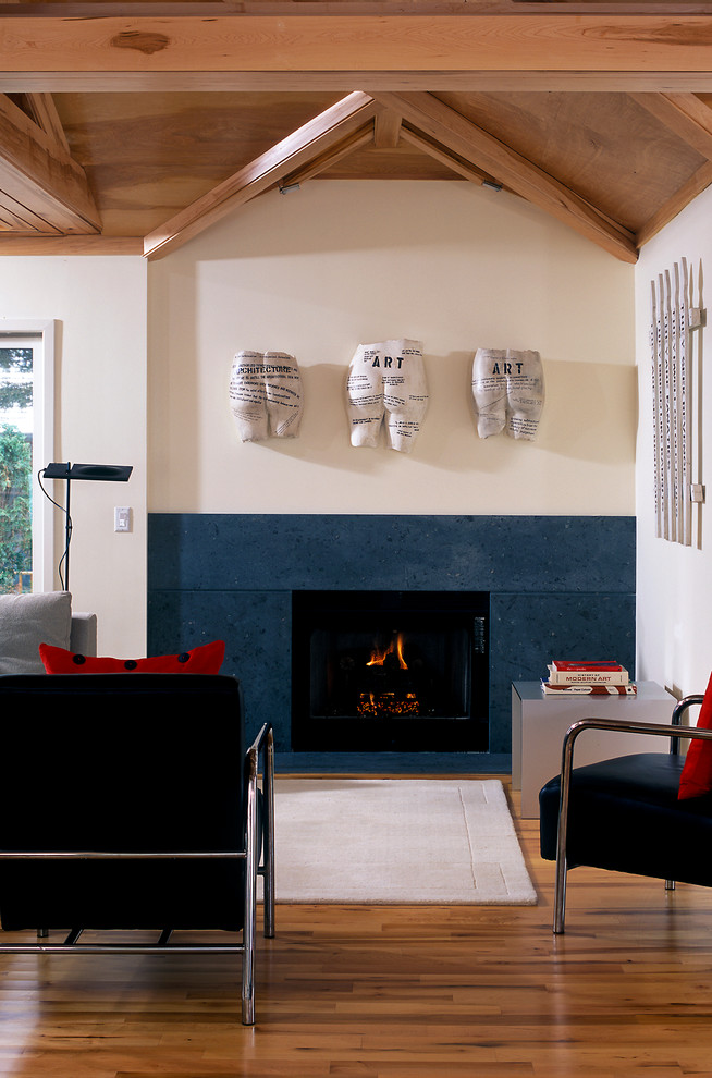 他の地域にある中くらいなコンテンポラリースタイルのおしゃれなリビング (白い壁、無垢フローリング、標準型暖炉、石材の暖炉まわり、テレビなし、茶色い床) の写真