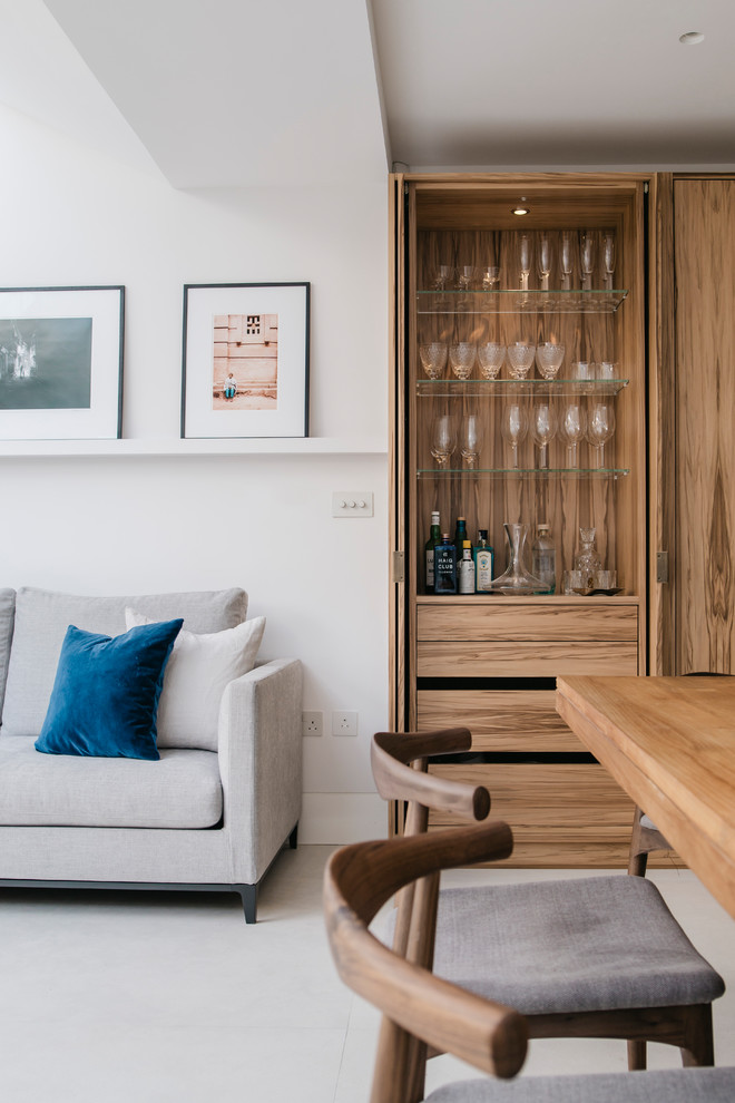 This is an example of a medium sized contemporary open plan living room in London with white walls and ceramic flooring.