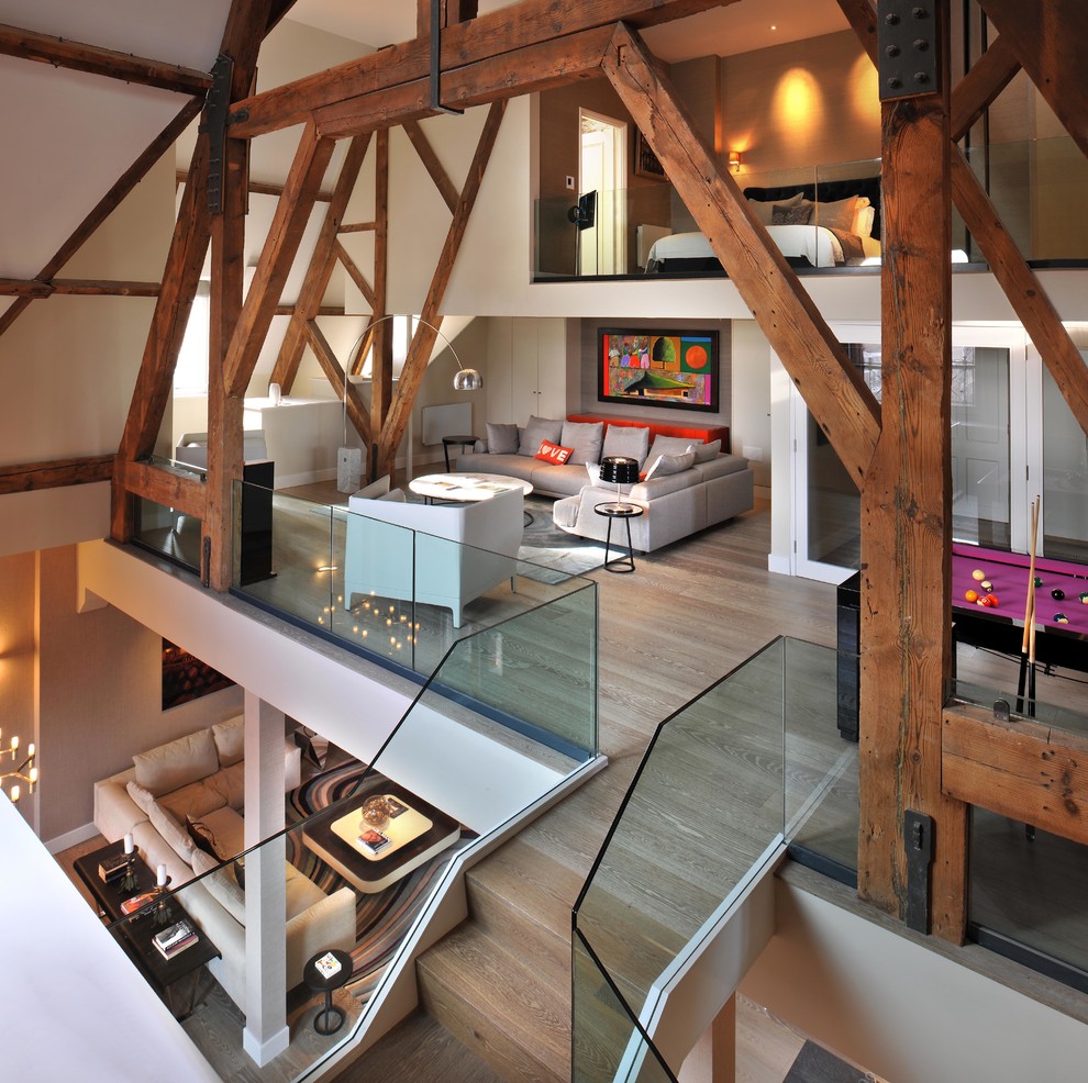 Example of a trendy loft-style medium tone wood floor and beige floor living room design in London