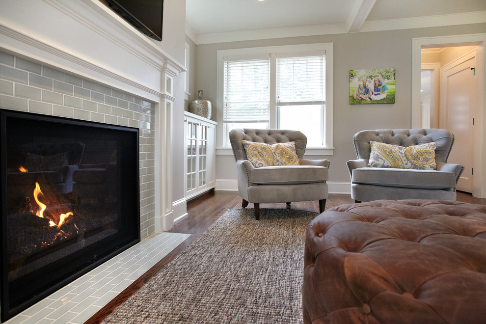 Mid-sized transitional enclosed medium tone wood floor living room photo in Minneapolis with gray walls, a standard fireplace, a tile fireplace and a wall-mounted tv