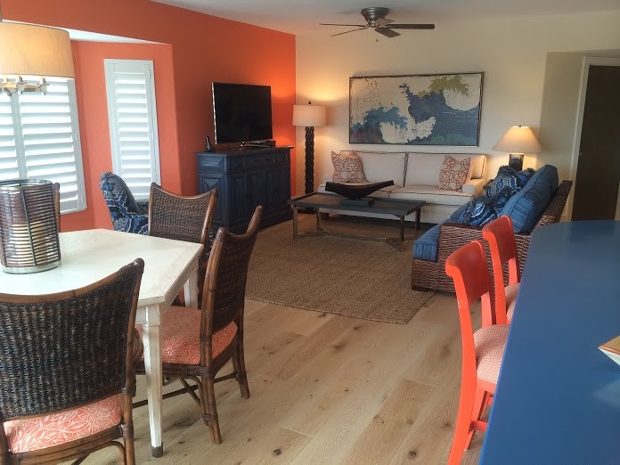Идея дизайна: открытая гостиная комната в морском стиле с оранжевыми стенами и отдельно стоящим телевизором