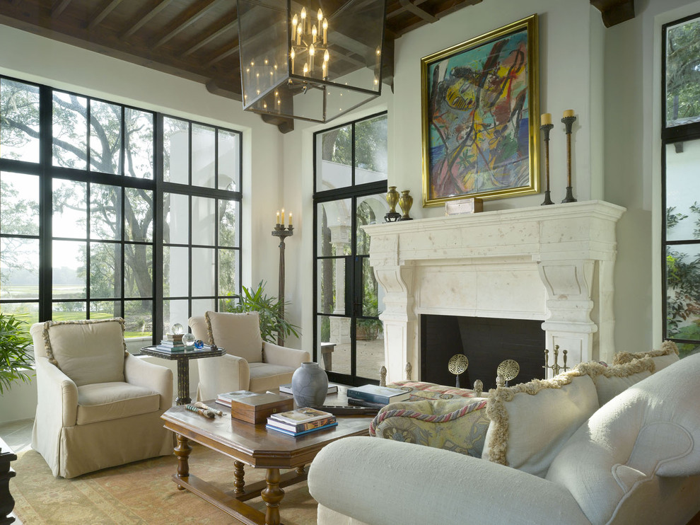 Tuscan living room photo in Atlanta with white walls and a standard fireplace