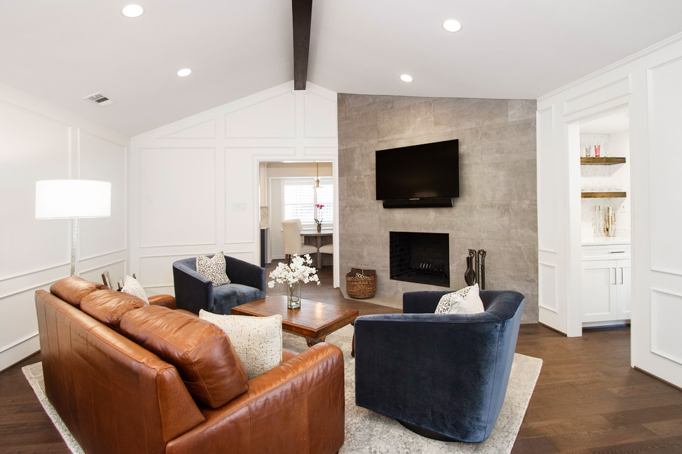 Mid-sized transitional enclosed brown floor and light wood floor living room photo in Dallas with white walls, a wall-mounted tv, a standard fireplace and a tile fireplace