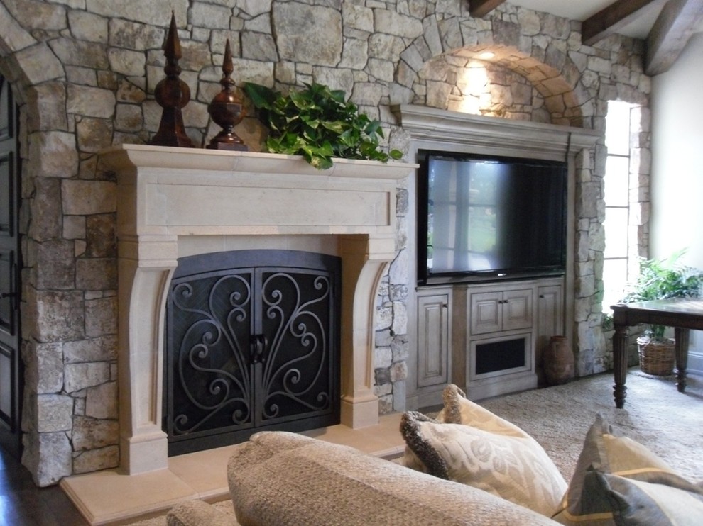 This is an example of a medium sized rustic enclosed living room in San Diego with white walls, carpet, a standard fireplace, a built-in media unit and beige floors.