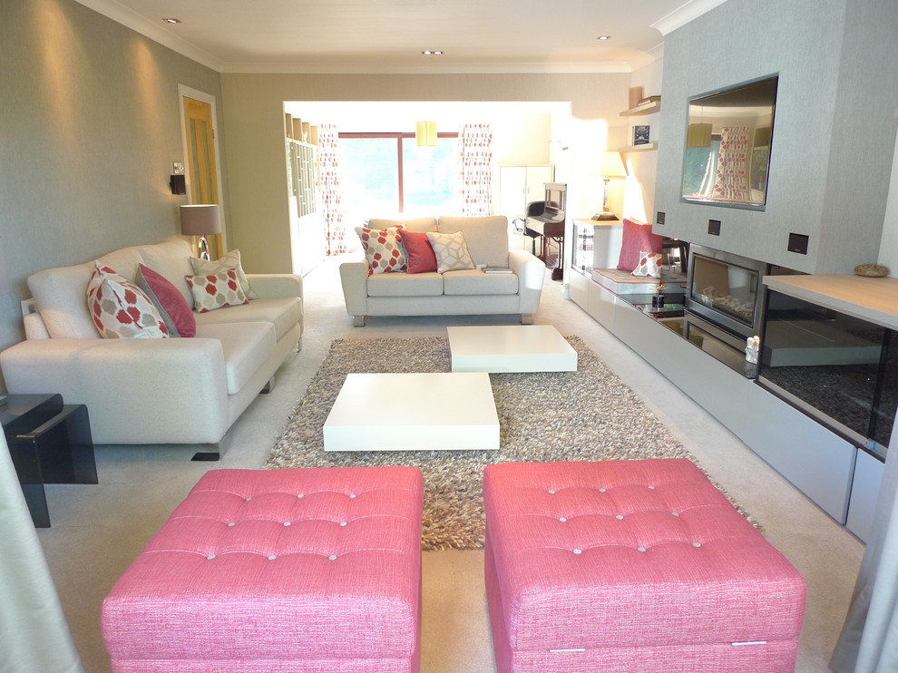 Photo of a large modern living room in West Midlands with beige walls, carpet, a ribbon fireplace, a plastered fireplace surround, a built-in media unit and beige floors.