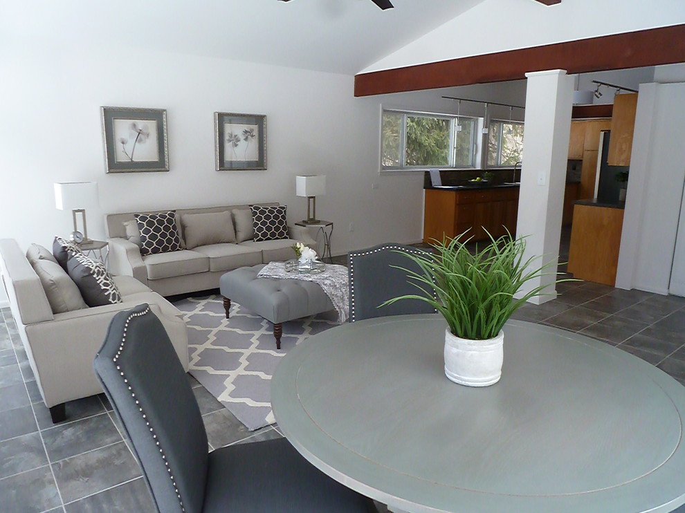 Esempio di un soggiorno chic con pareti bianche, pavimento in gres porcellanato e pavimento grigio