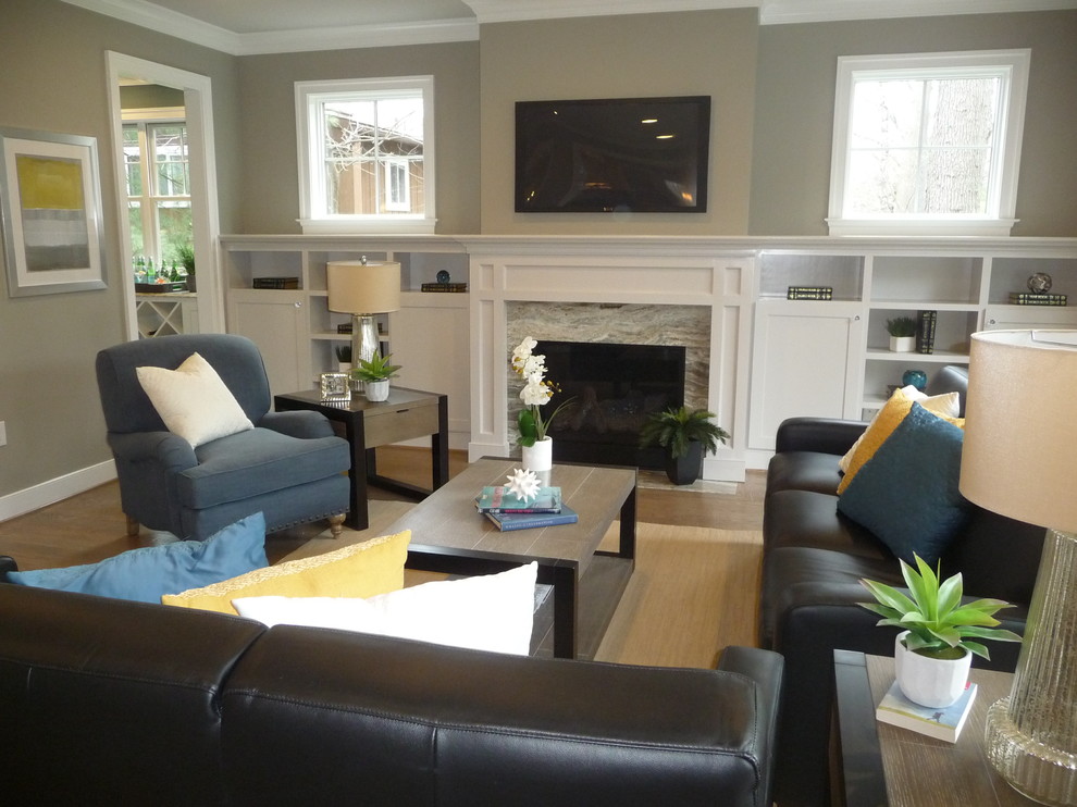 This is an example of a medium sized contemporary enclosed living room in DC Metro with grey walls, medium hardwood flooring, a standard fireplace, a wooden fireplace surround, a wall mounted tv and brown floors.