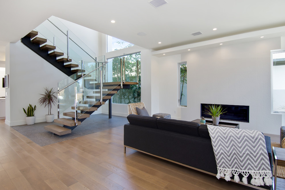 Photo of a large contemporary open plan living room in Los Angeles with medium hardwood flooring.
