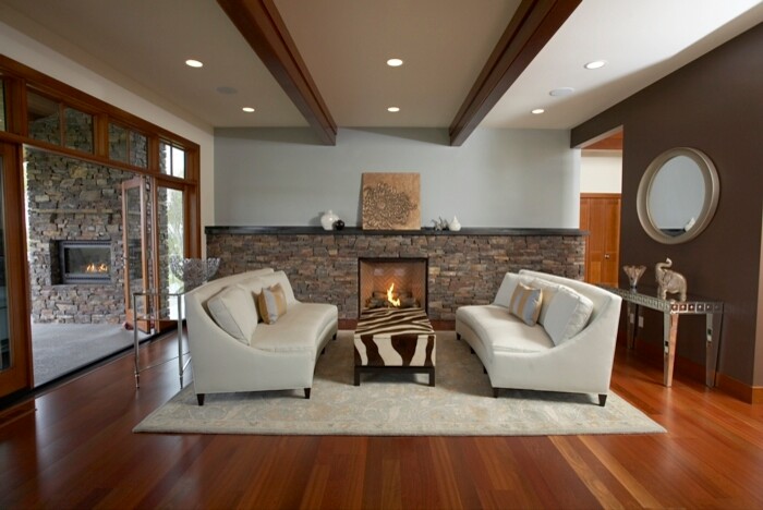 Large contemporary open plan living room in Seattle with blue walls, dark hardwood flooring, a standard fireplace and a stone fireplace surround.