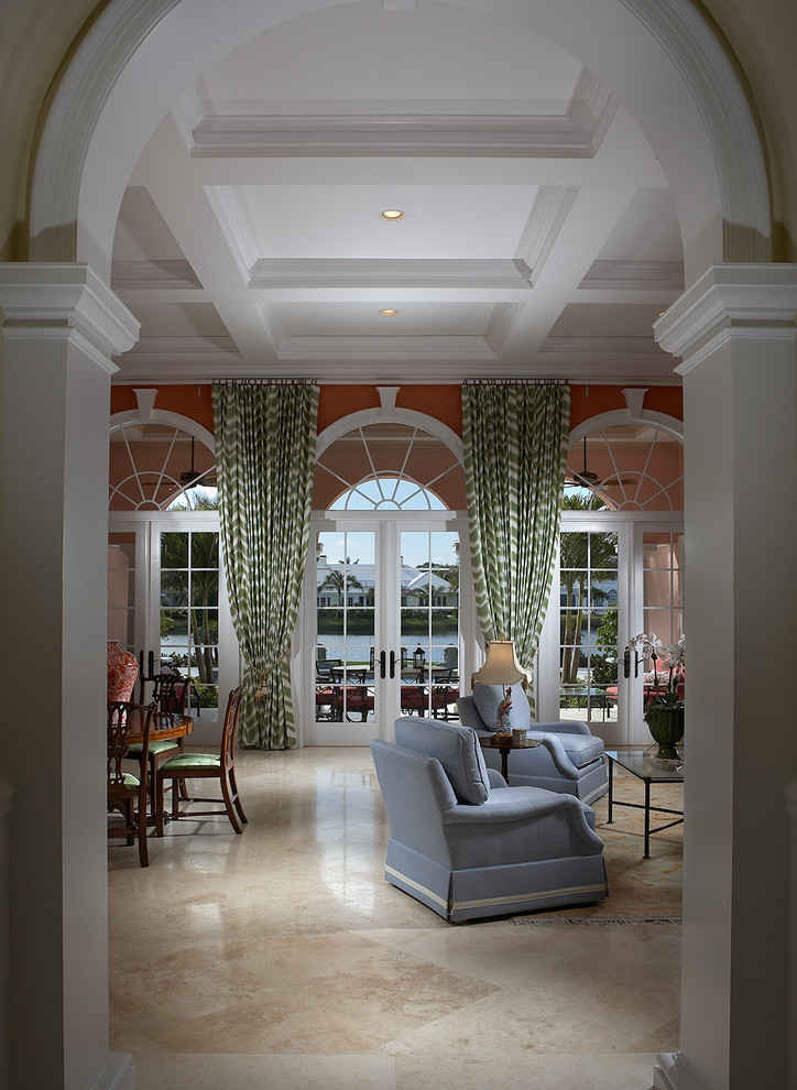 Cette photo montre un salon chic de taille moyenne et fermé avec une salle de réception, un mur rouge, un sol en marbre, une cheminée standard, un manteau de cheminée en bois, aucun téléviseur et un sol beige.