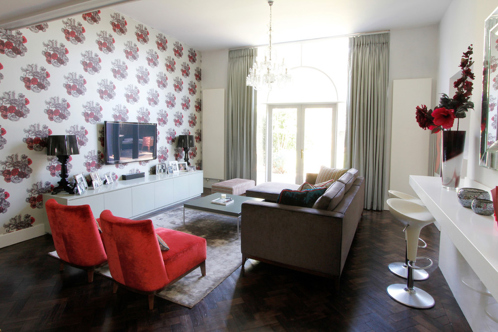 Example of a trendy dark wood floor living room design in London with no fireplace and a wall-mounted tv