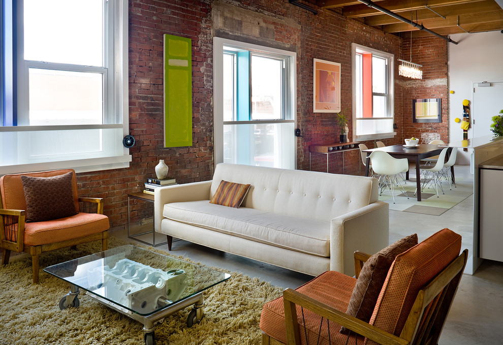 Contemporary open plan living room in Kansas City with concrete flooring.