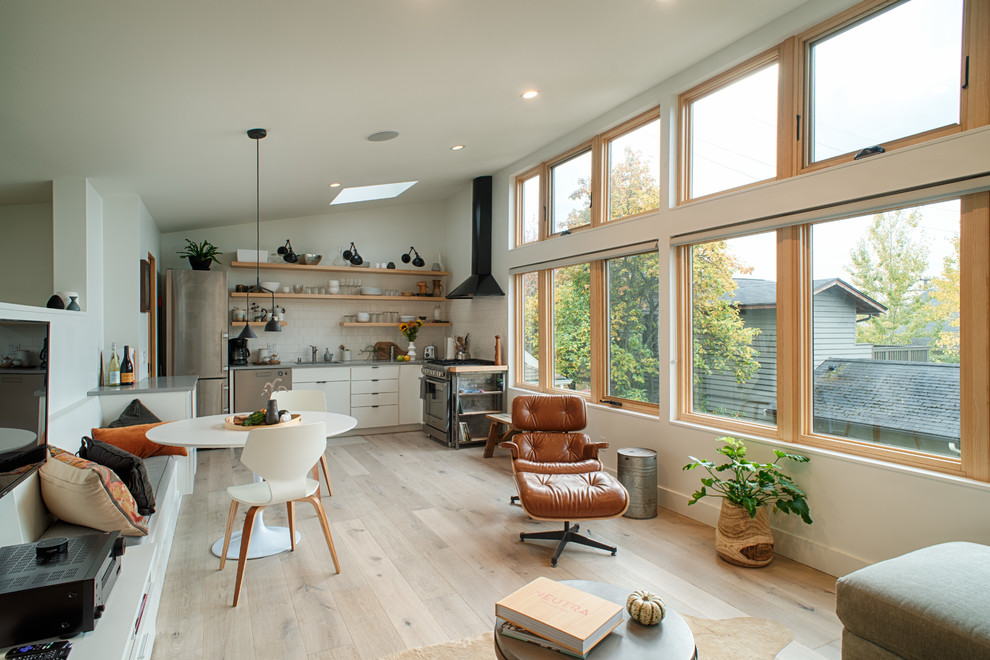 Foto de salón abierto contemporáneo pequeño con paredes blancas, suelo de madera clara y suelo beige
